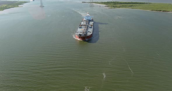 Aerial establishing shot of large tanker boat in water