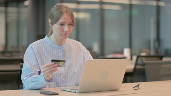 Young Woman Making Successful Online Payment on Laptop