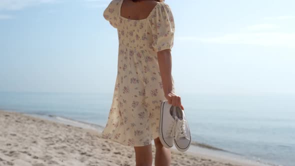 Elegant Girl Running Sand Beach in Straw Hat Back View