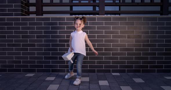 Happy Little Girl Playing In The Yard In Summer