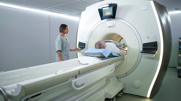 Magnetic Resonance Imaging in the Modern Hospital Young Woman Doctor Performs a Magnetic Tomographic