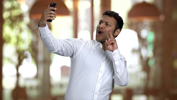 Hindu Businessman Posing and Taking Selfie Using His Frontal Camera