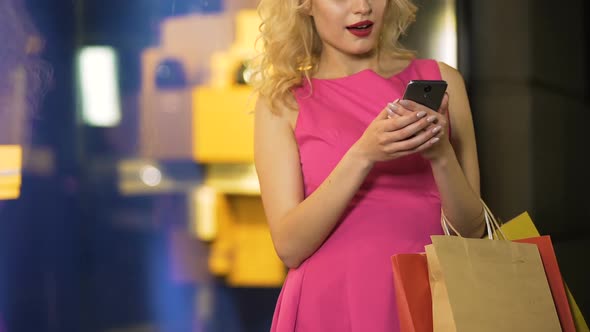 Female Shopaholic Checking Prices of Her Purchases at Online Stores Mobile App