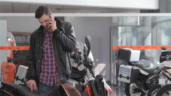Talks On The Phone Near Motorbike