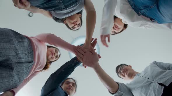 Group of happy asian employee joining stack hands together