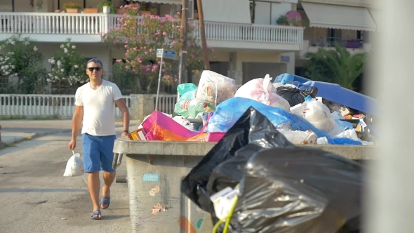 Man Throwing Trash Pack To Container
