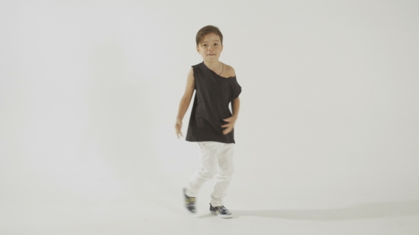 Stylish Little Boy In Black T-Shirt Dancing And Having Fun