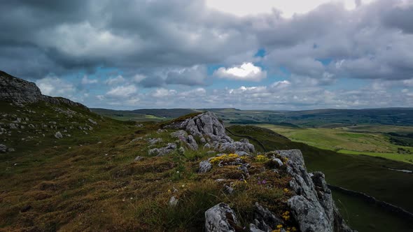 Time-lapse panning shot looking over the upper Eden Valley Cumbria with fasting clouds casting their