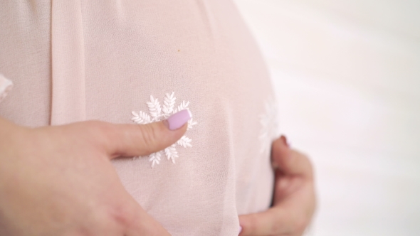 Pregnant Woman Stroking Big Belly In Nightyon White Background. 