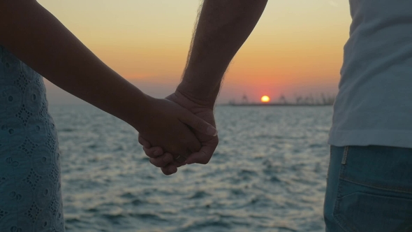 Hand In Hand By The Sea At Sunset