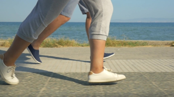 Legs Of Two Running People