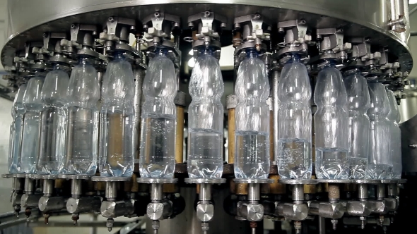 The Machine Is Pouring Mineral Water Into Bottles