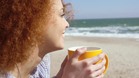 Beautiful Pensive Redhead Woman at the Beach Watching the Sea