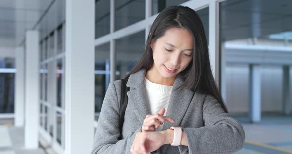 Business woman using smart watch at outdoor