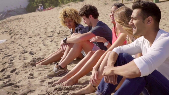 Group Of Multiracial People Sitting On a Beach