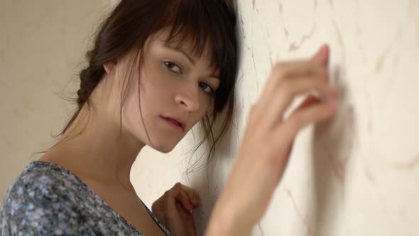 Young Woman Leaning On The Wall