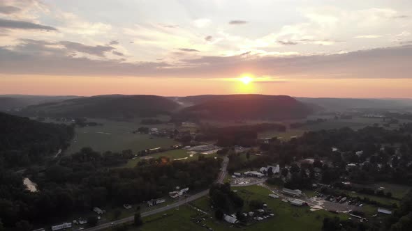 Descending aerial view of the sunset in a town in Maine, United States of America