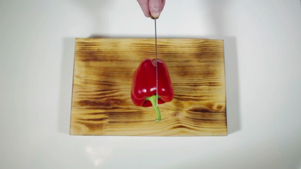 Man Chopped Red Bell Pepper On a Cutting Board 