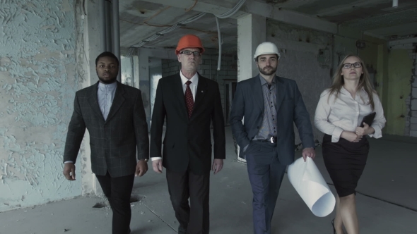 Team Of Builders In Suits, Hard Hat, Move, Look Directly Into Camera. Black Man, Aged Engineer