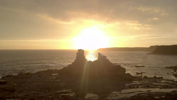 Aerial shot of the silhouette of eagles nest in the beautiful glow of the sunset.