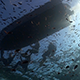 Divers Getting Into Dingy Shot From Below With Sun Breaking the Surface - VideoHive Item for Sale