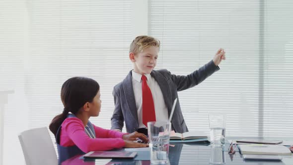 Kids as business executives having a meeting in the board room 4k