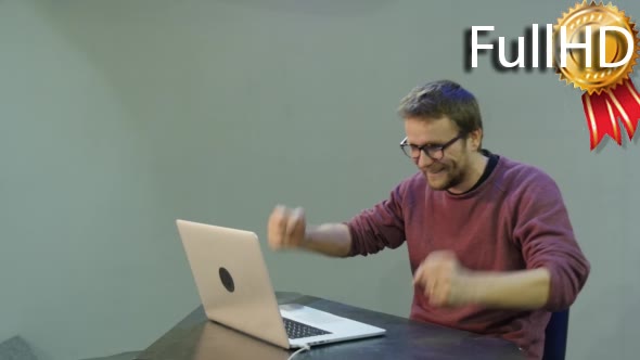 Man Typing Fast on Laptop Takes a Glasses Off