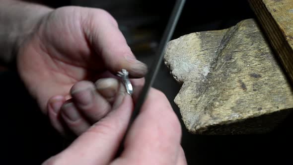 Closeup of Wedding Ring Polishing By Caicasian Jeweler Isolated  Footage