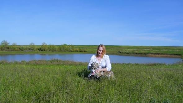 Pretty Girl Plays With a Dog On The Grass By The Lake Nature Animals Pets Friend Emotions Happy