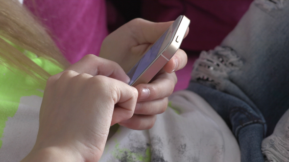 Young Girl Using Smartphone At Home 01