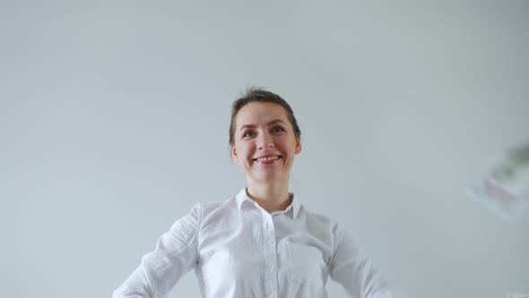 Happy Formally Dressed Woman Making Money Rain From Dollar Bills