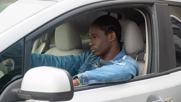 African American Man Sitting in His Luxury Car