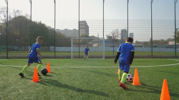 Young Football Players Training To Score Goals