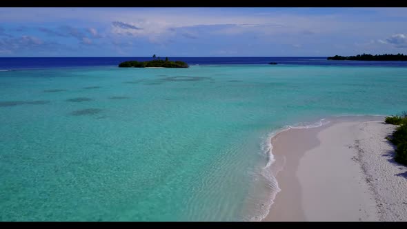 Aerial drone view abstract of idyllic seashore beach holiday by blue ocean with white sandy backgrou