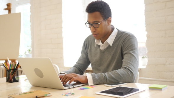 Young Creative Man Working in Office