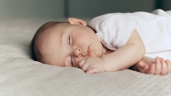 Sleeping Cute Baby Boy on Gray Blanket