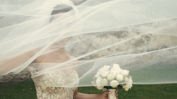 Wedding Bride Fun With Veil On Wind