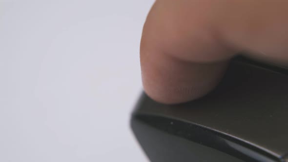 Man Works with Black Computer Mouse on White Surface