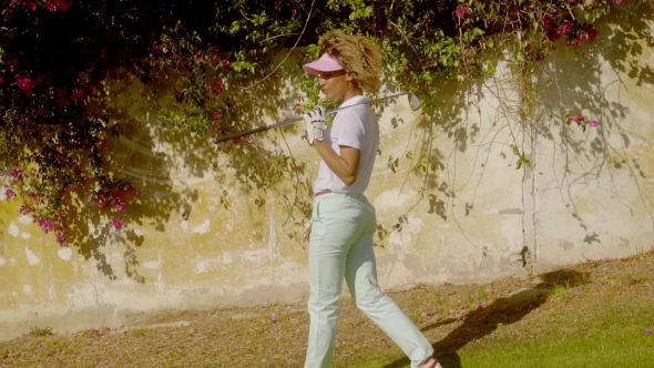 Woman Golfer Posing In Front Of Bougainvillea