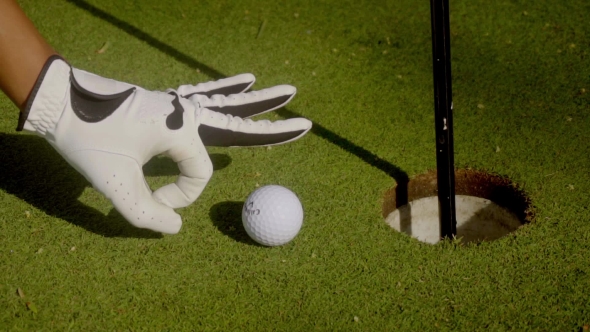 Golfer Preparing To Nudge a Ball Into The Hole