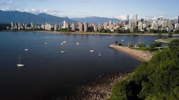 Stunning Landscape Of Downtown Skyline And English Bay Beach From Kitsilano Beach With Sailboats On