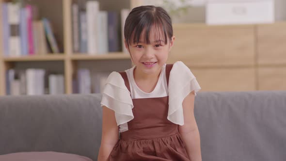 Portrait of asian children smile looking at camera at home