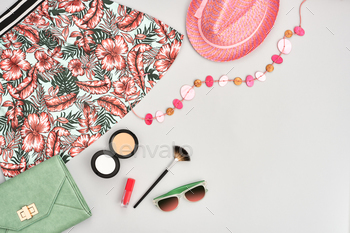 metics, makeup accessories. Stylish handbag clutch, trendy pink dress, necklace hat, sunglasses. Woman essentials. Unusual overhead, top view on gray