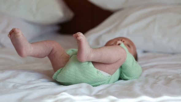Newborn Baby Lying On a Bed