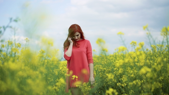 Girl With Bouquet Of Rape Blossom In The Field, Wind Blowing, Cloudy Sky 