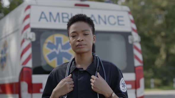 African American Female Paramedic in Uniform Posing Outdoors