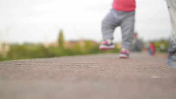 Little Girl Learning To Walk With His Mother, First Steps, Park, Sunny Day