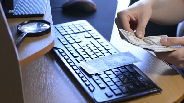 The Man In The Office Counting Money At The Computer Table