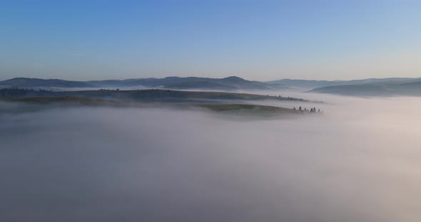 Thick Fog Covered The High Mountains. Dawn In The Carpathians