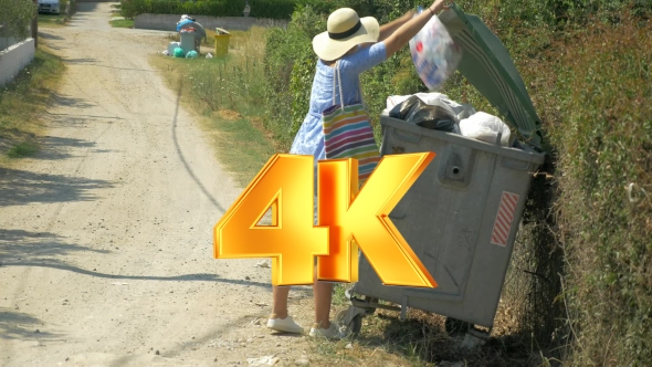 Woman Taking Out The Litter To Street Container